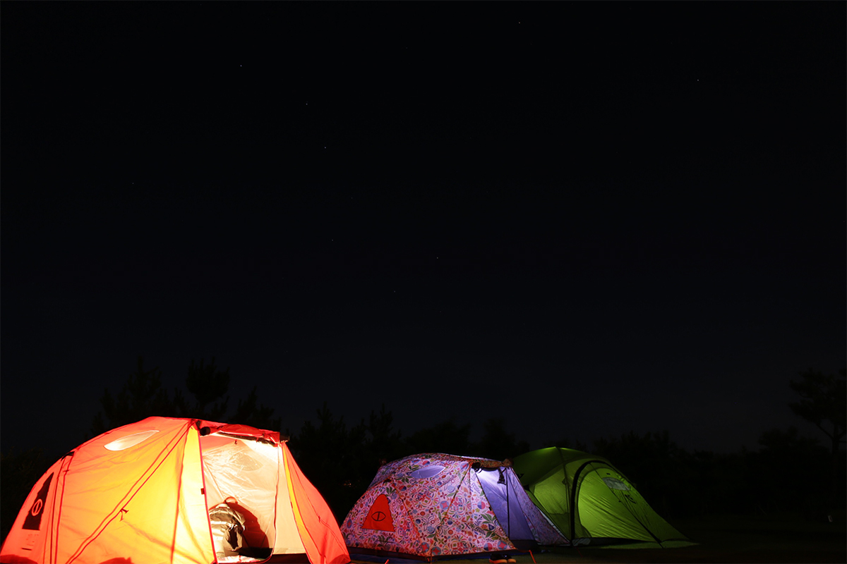 Three tents with Star-filled night sky